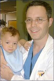 doctor holding small child